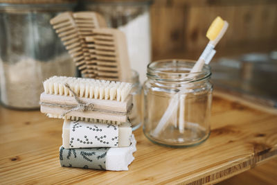 Stack of soaps and scrubbing brush on table