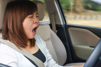 Portrait of woman sitting in car