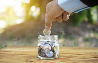 Close-up of a hand holding jar