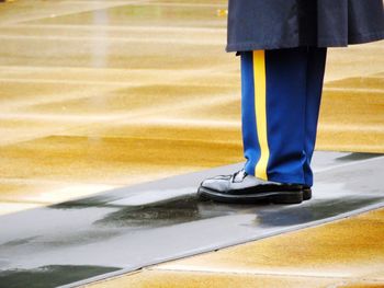 Low section of person standing on street