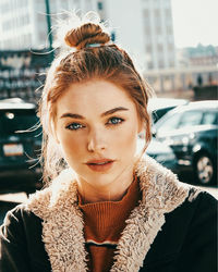 Portrait of young woman in city