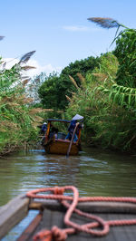 Boat in river against sky