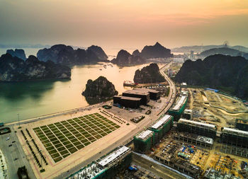 High angle view of cityscape by sea against sky