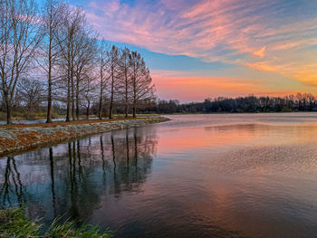 Scenic view of lake against sky during sunrise 