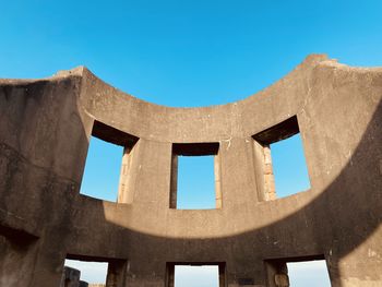 Low angle view of historical building against clear blue sky