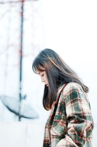 Side view of young woman looking down