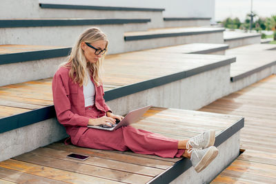 Portrait of young woman using mobile phone