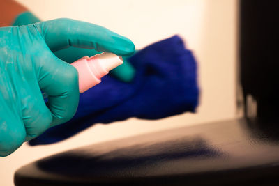 Close-up of hand holding blue paper