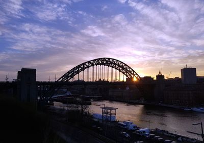 View of bridge over river against cloudy sky