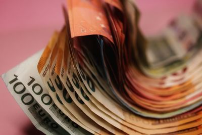 Close-up of open book against colored background