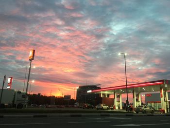 Cars on street at sunset