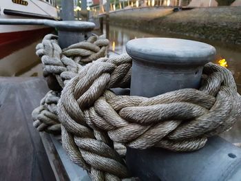 Close-up of rope tied up at harbor