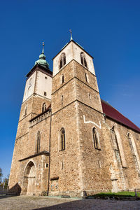 Low angle view of historic building against clear blue sky