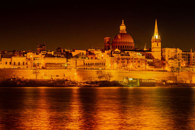 Illuminated buildings at waterfront