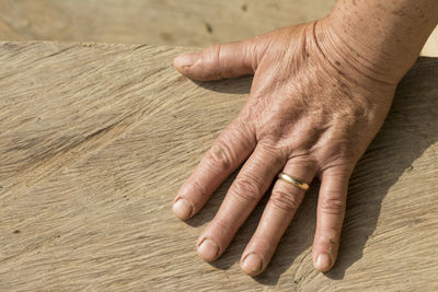 High angle view of man hands on wood