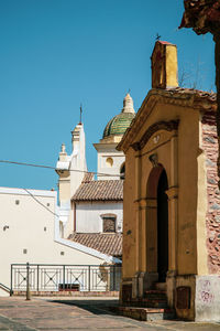 Exterior of buildings against clear blue sky