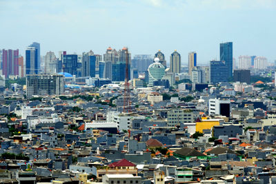 High angle view of buildings in city against sky