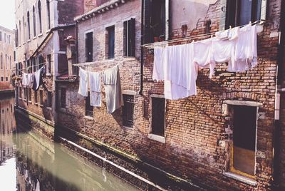 Clothes drying against buildings in city