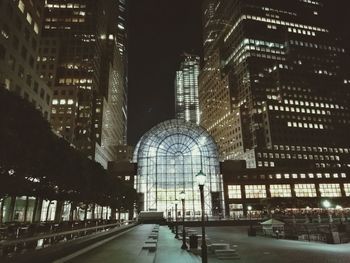 View of skyscrapers in city at night