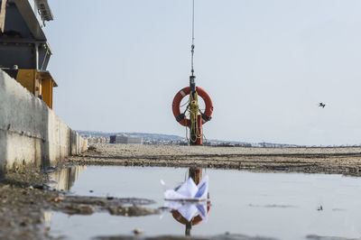 Man hanging against clear sky