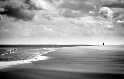 View of beach against cloudy sky