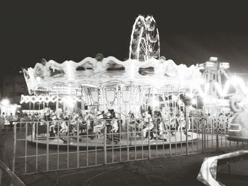 Illuminated carousel at night