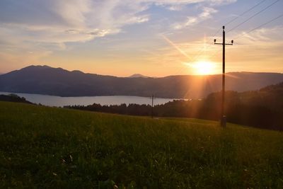 Scenic view of field against sky during sunset