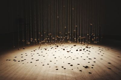 Illuminated lighting equipment on table against wall