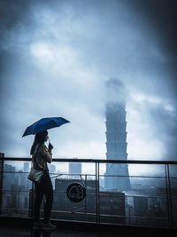 Women standing on rainy day