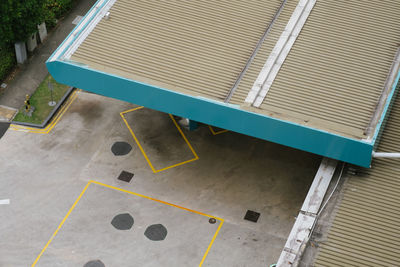 High angle view of empty bench against building