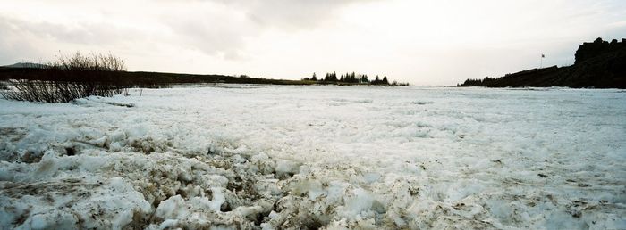 Scenic view of landscape against sky during winter