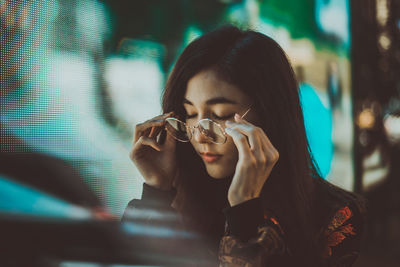 Portrait of a young woman drinking glass