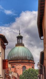 Low angle view of temple against cloudy sky