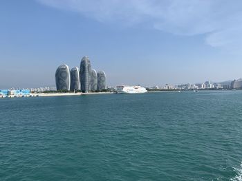 Sea and buildings against sky