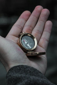 Close-up of hand holding clock