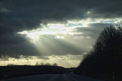View of storm clouds over road