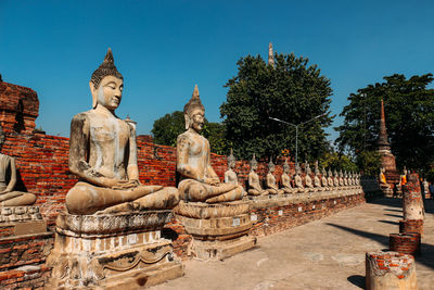 Statues at temple against trees