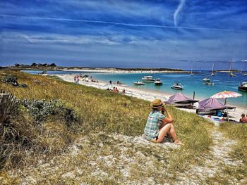 Panoramic view of people on beach against sky