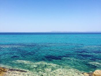 Scenic view of sea against clear blue sky