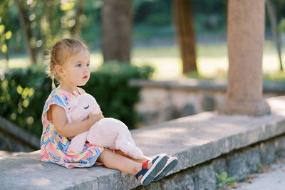 Portrait of boy sitting on bench