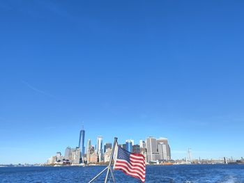 Us flag in front of manhattan skyline 