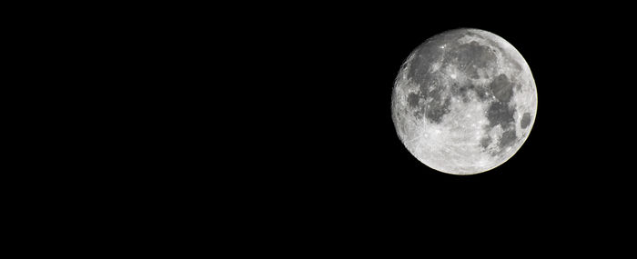 Low angle view of moon against sky at night