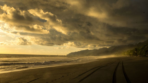 Scenic view of beach against sky during sunset