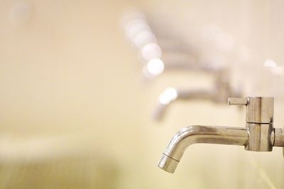 Close-up of faucet in bathroom