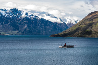 Scenic view of sea and mountains against sky