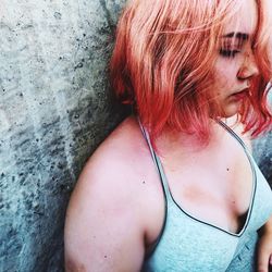 Close-up portrait of woman against wall