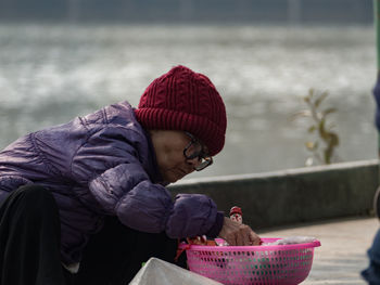 Rear view of girl in basket during winter