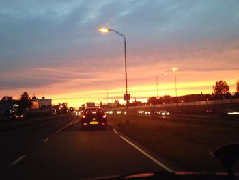 Cars on road at sunset