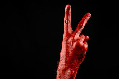 Close-up of human hand against black background