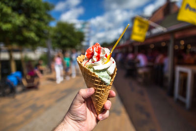 Close-up of hand holding ice cream cone